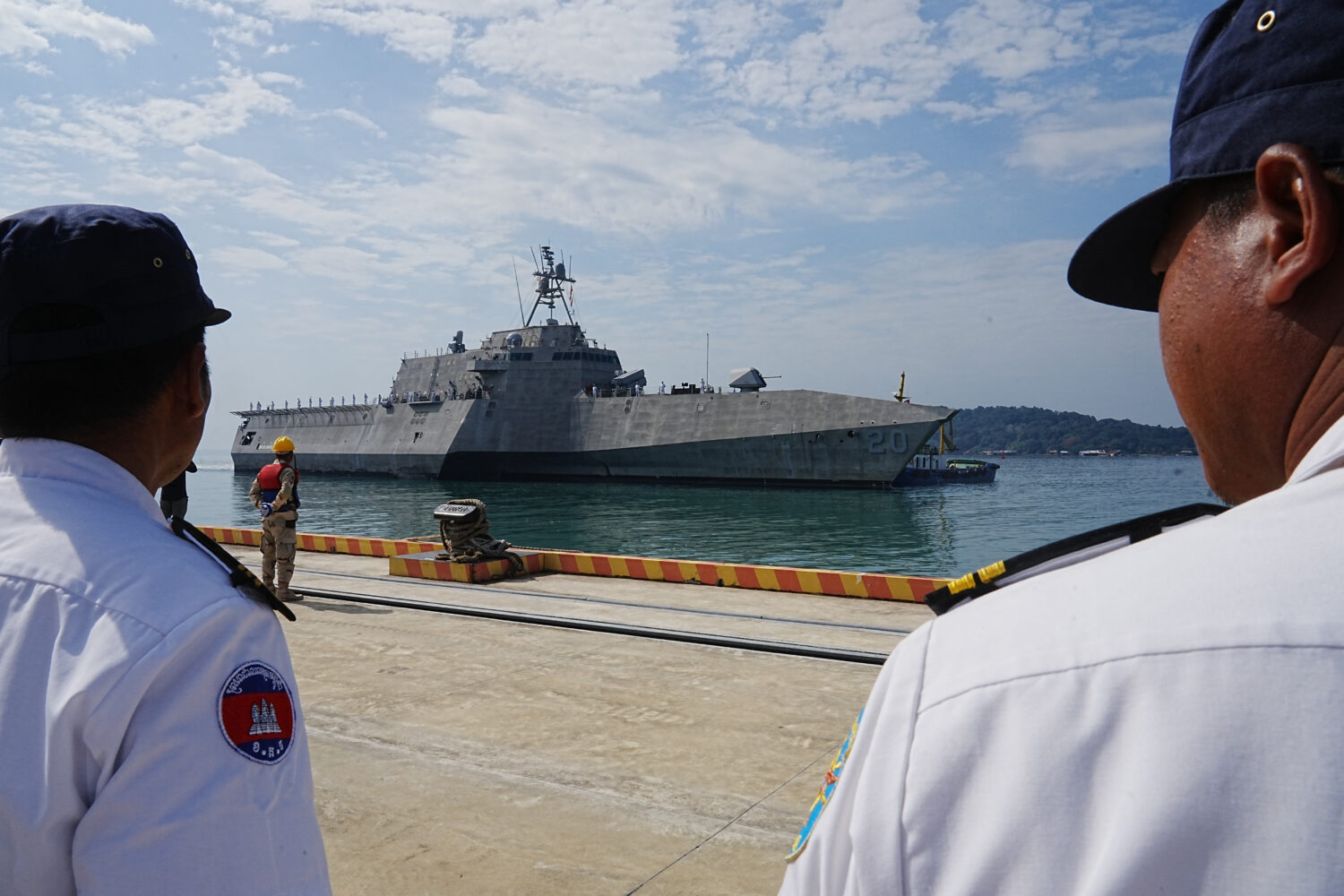 Cambodian naval members welcome U.S. warship USS Cincinnati, getting docked upon arrival at Ream Na...