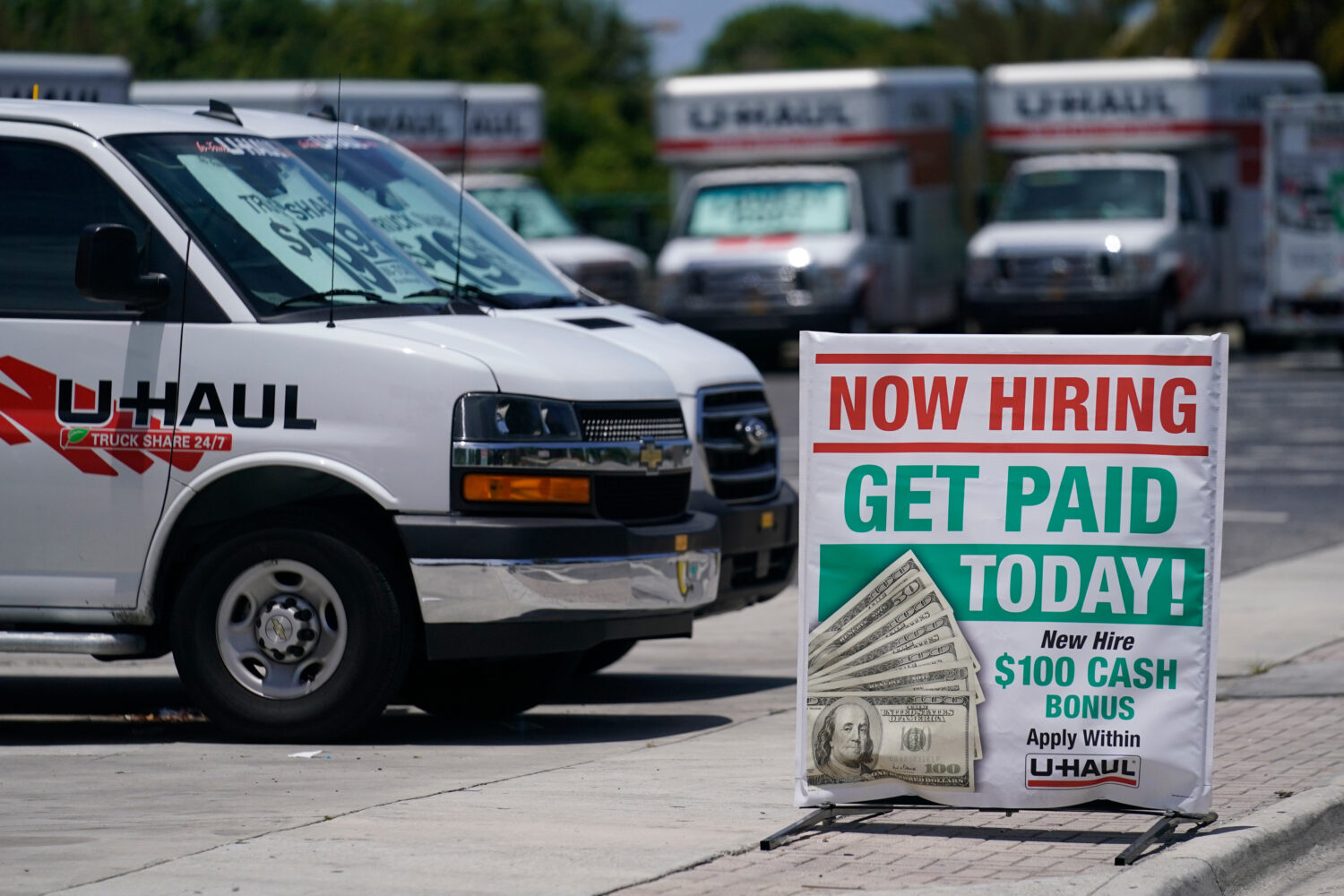 FILE - A sign at a UHaul store looking to hire employees is also offering a bonus, Thursday, May 20...