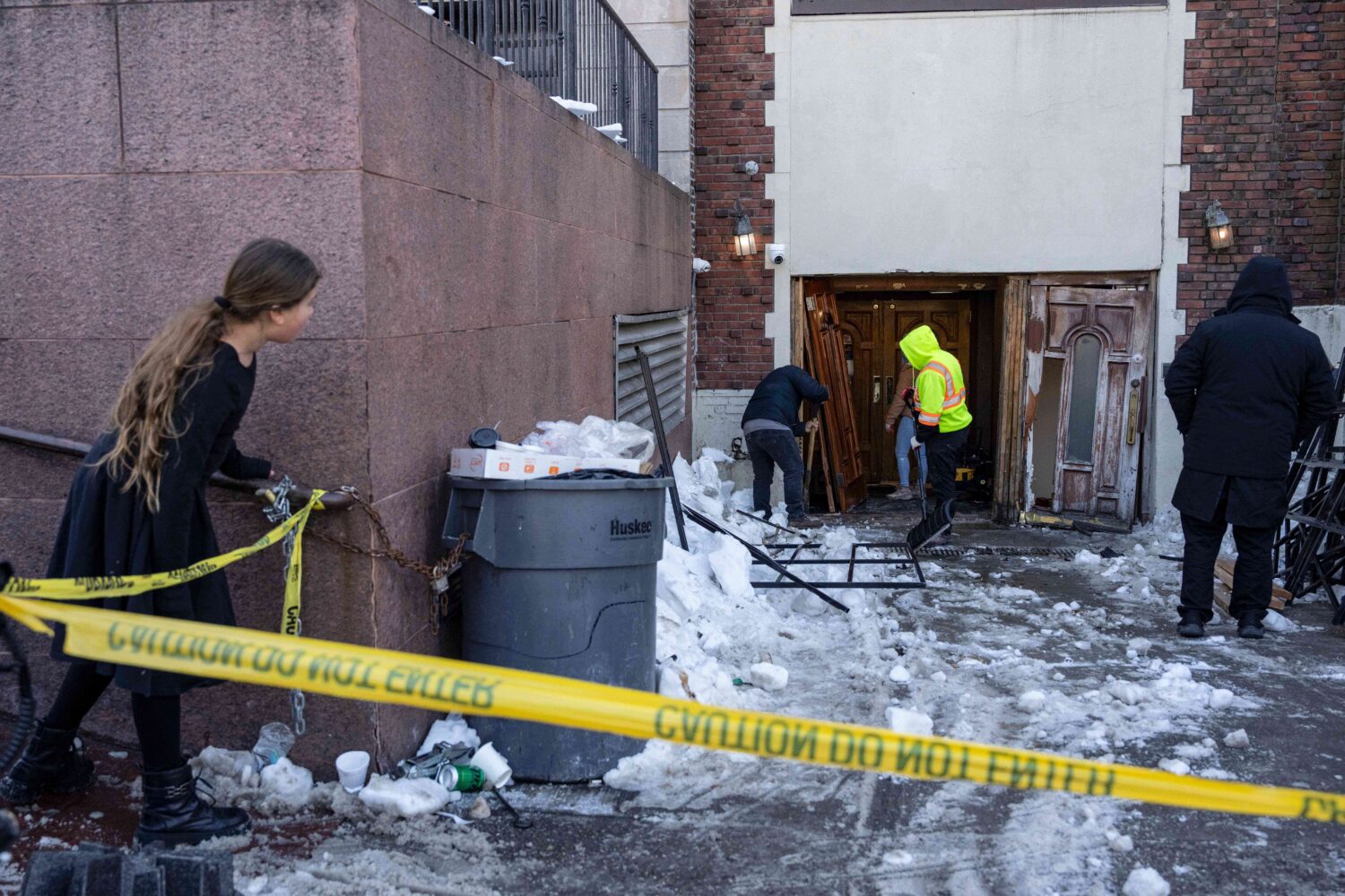 A person watches the scene where a car slammed into the entrance of the Chabad Lubavitch world head...