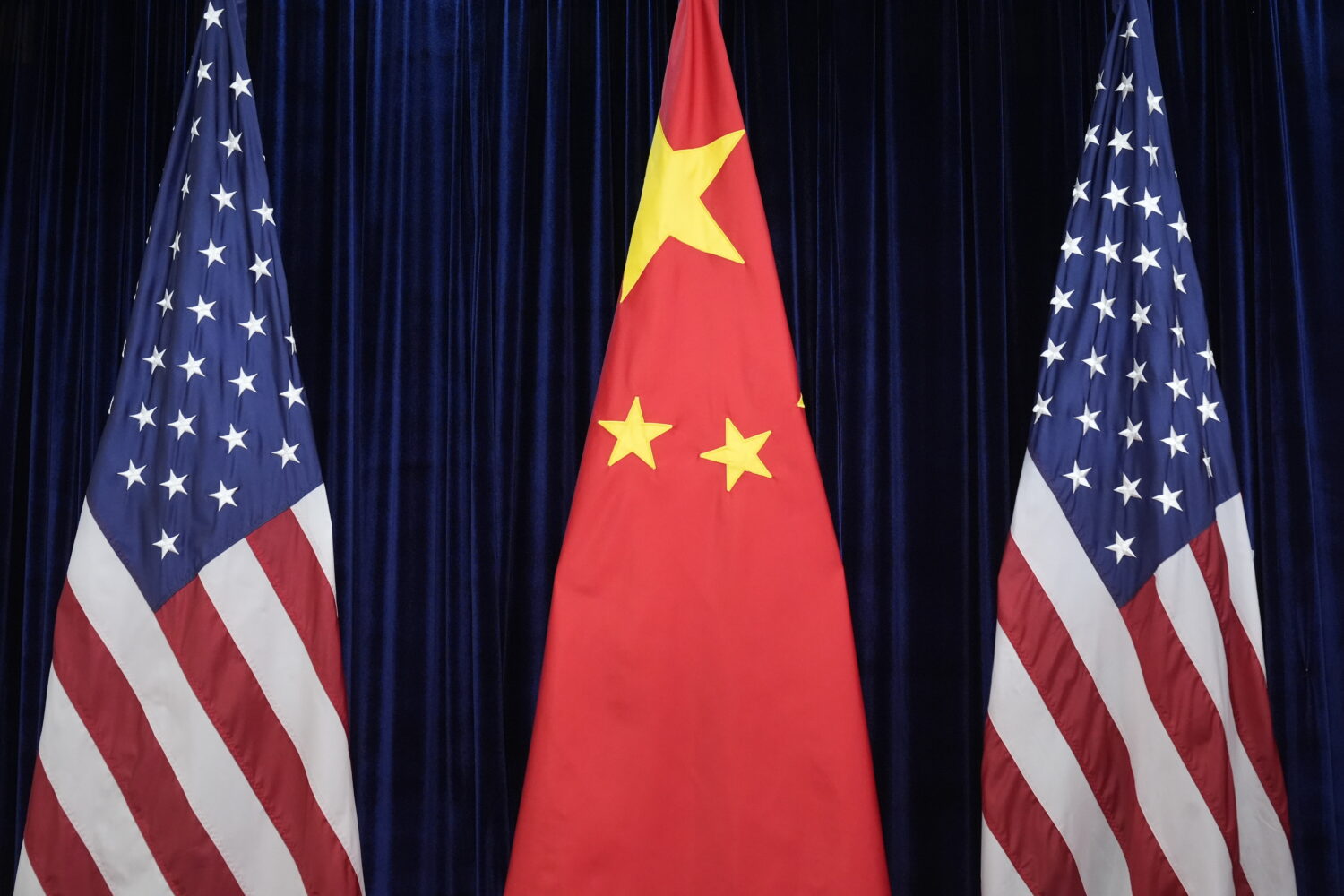 FILE - Flags of the U.S. and China are displayed at the Gimhae International Airport in Busan, Sout...