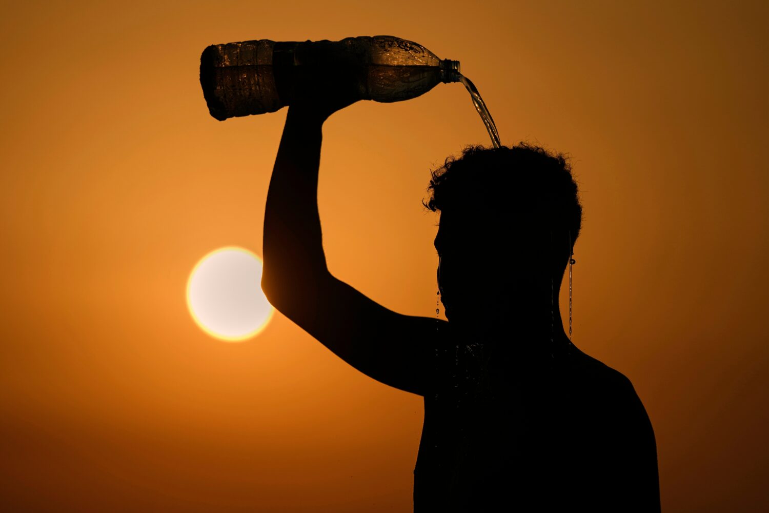 FILE - A man rinses with water after playing beach footvolley on the Ramlet al-Baida public beach i...