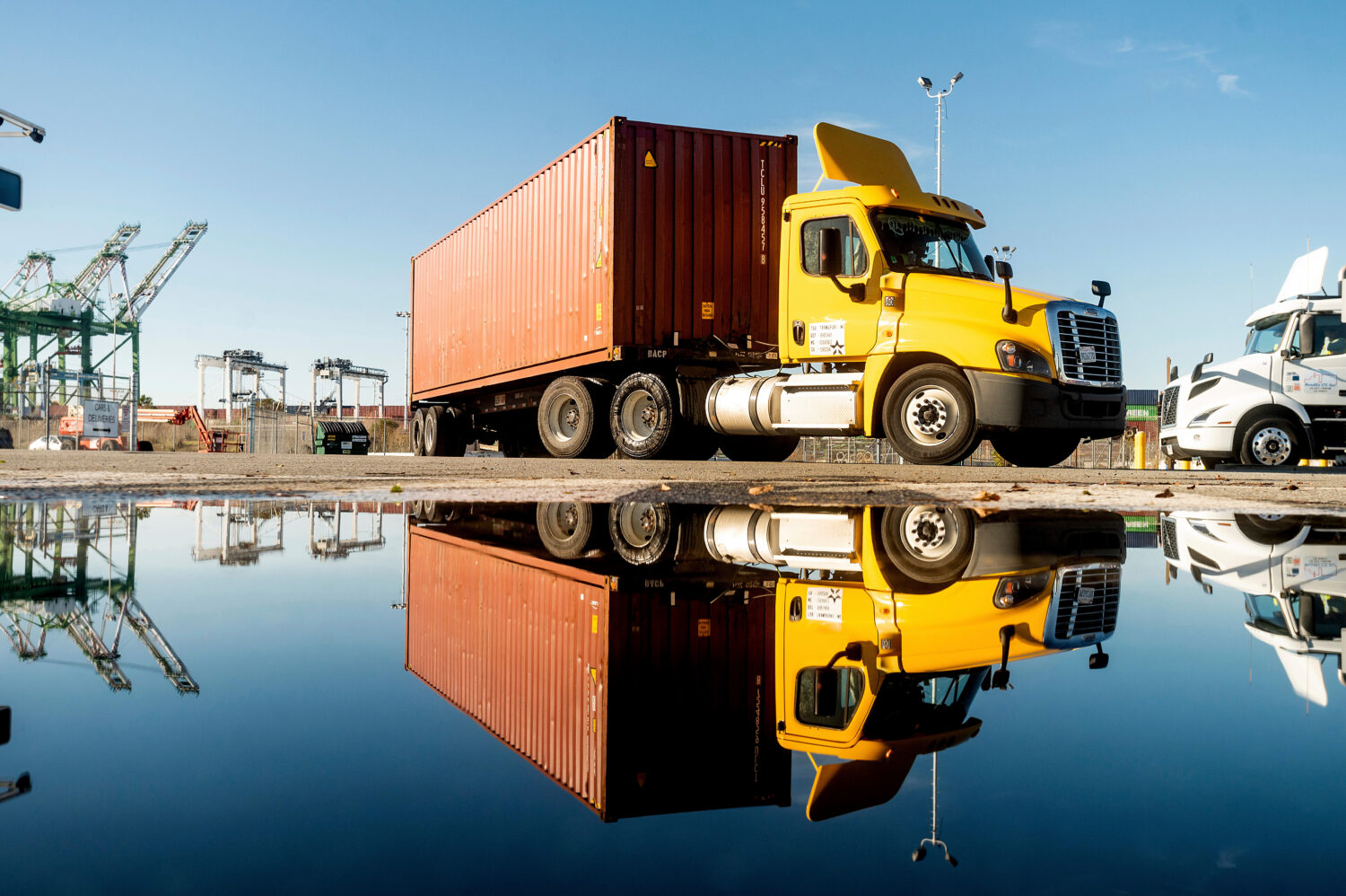 FILE - A truck departs from a Port of Oakland shipping terminal on Nov. 10, 2021, in Oakland, Calif...