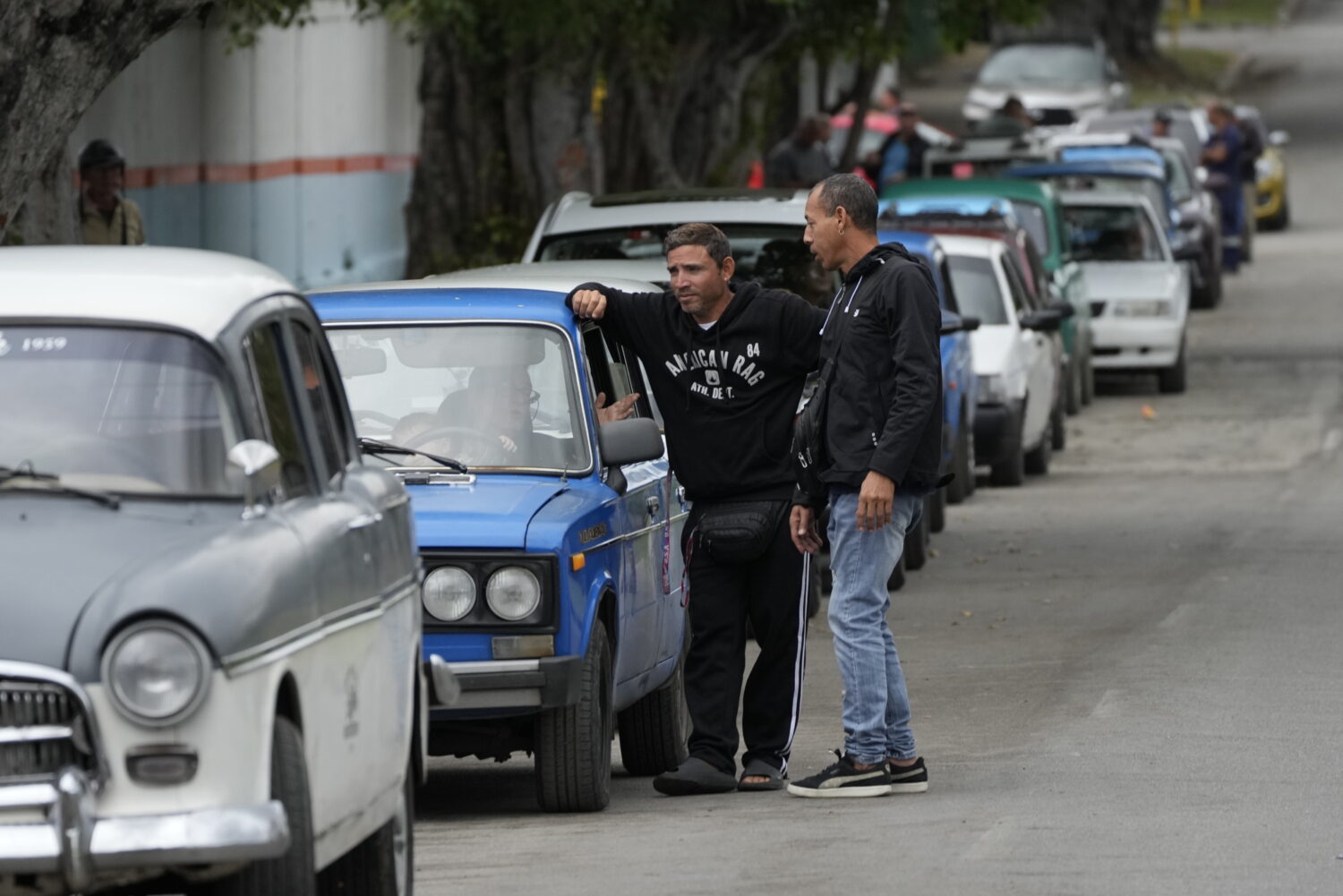 Drivers wait in a long line to enter a gas station in Havana, Cuba, Friday, Jan. 30, 2026. (AP Phot...