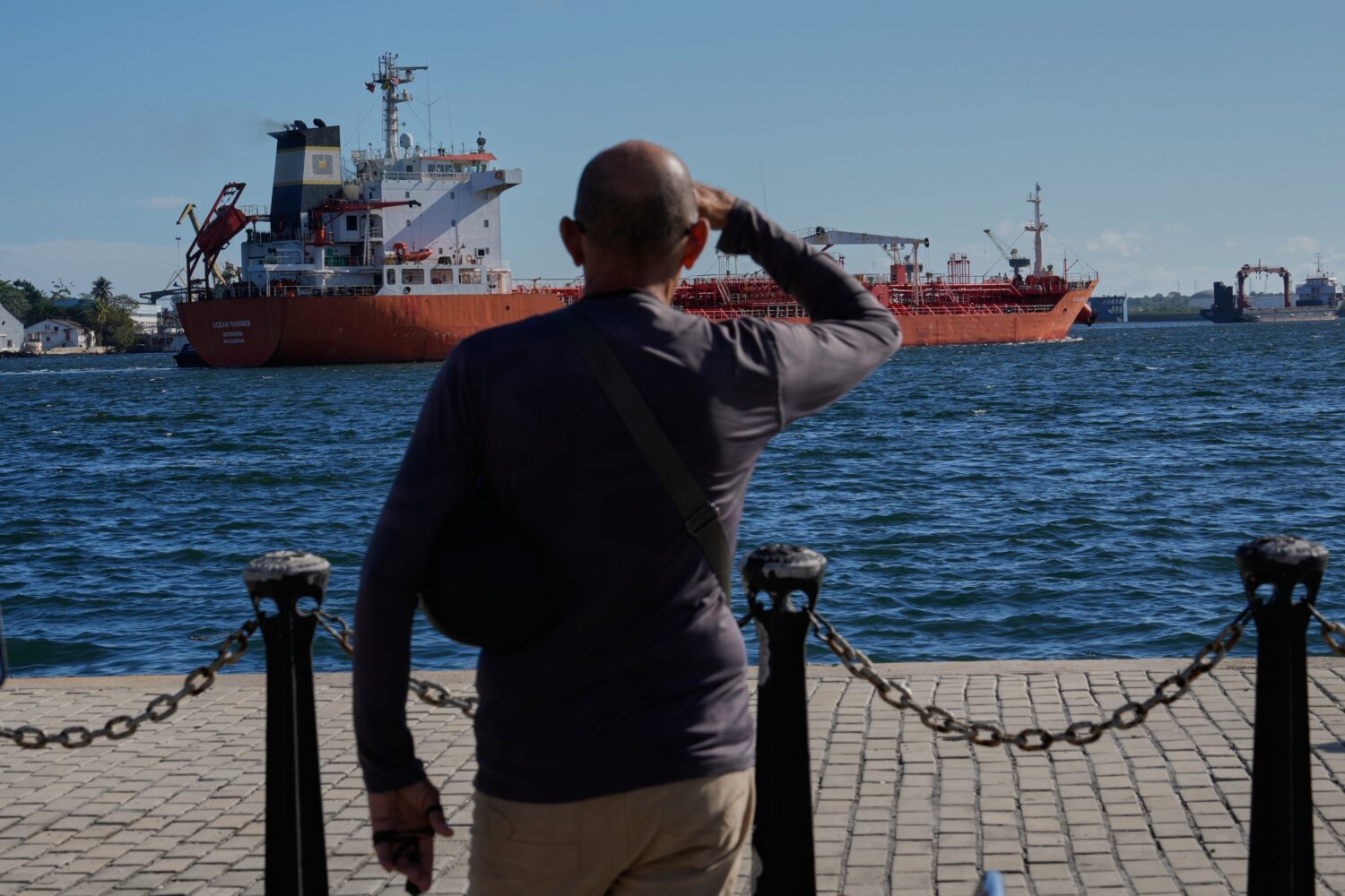 A person watches the oil tanker Ocean Mariner, Monrovia, arrive to the bay in Havana, Cuba, Friday,...