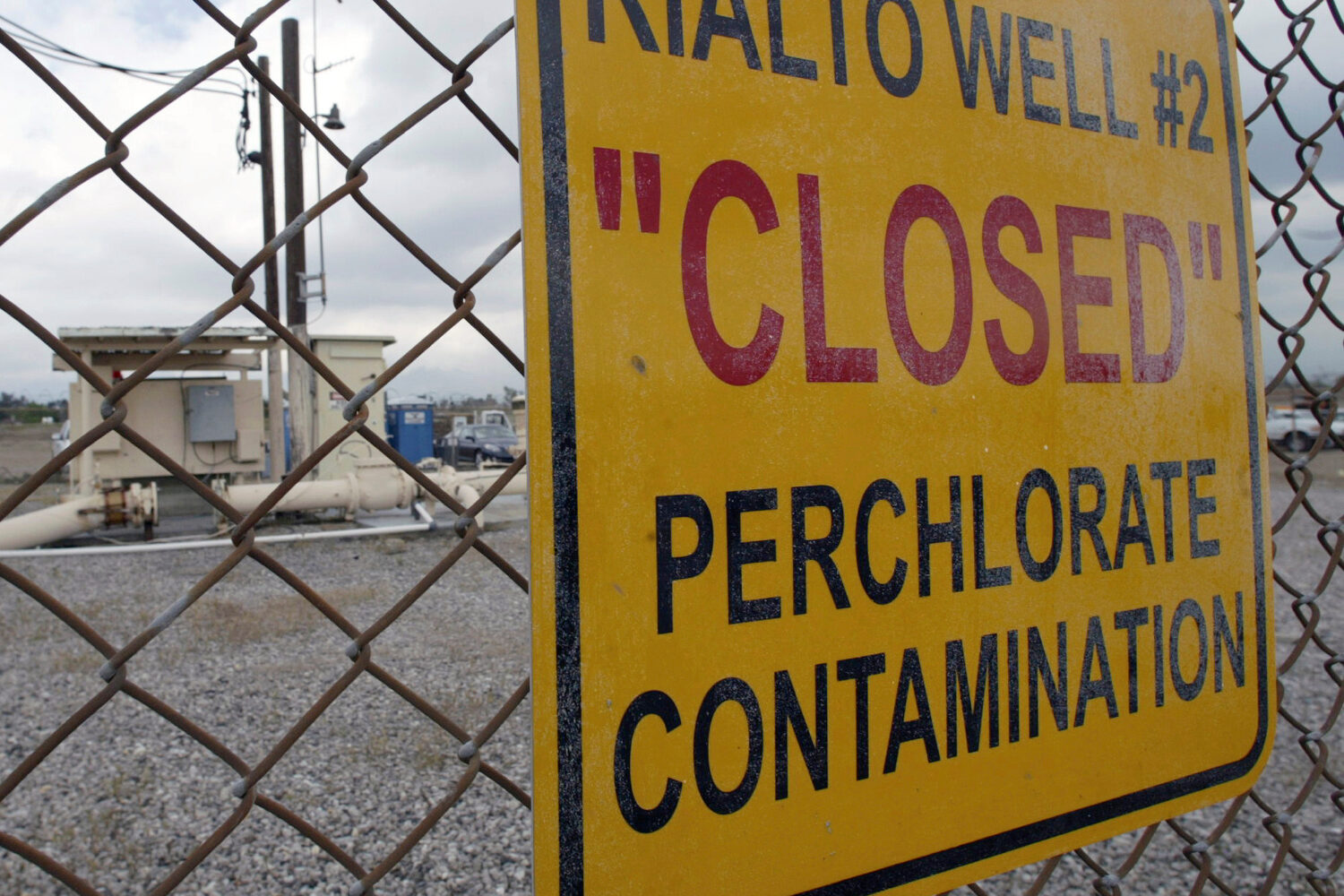 FILE - A sign is posted outside a water well indicates perchlorate contamination at a site in Rialt...