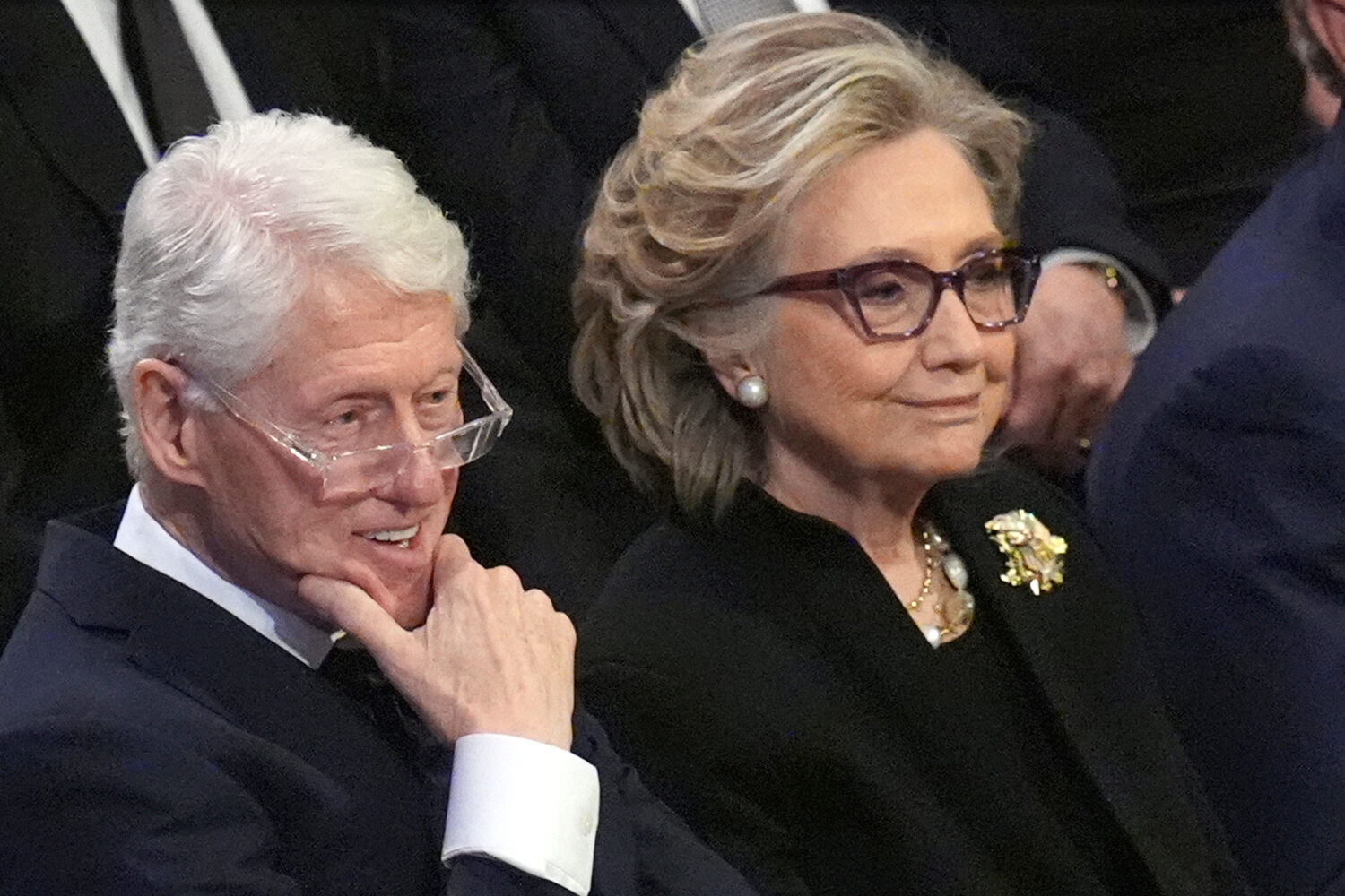 FILE - Former President Bill Clinton and former Secretary of State Hillary Clinton listen during th...