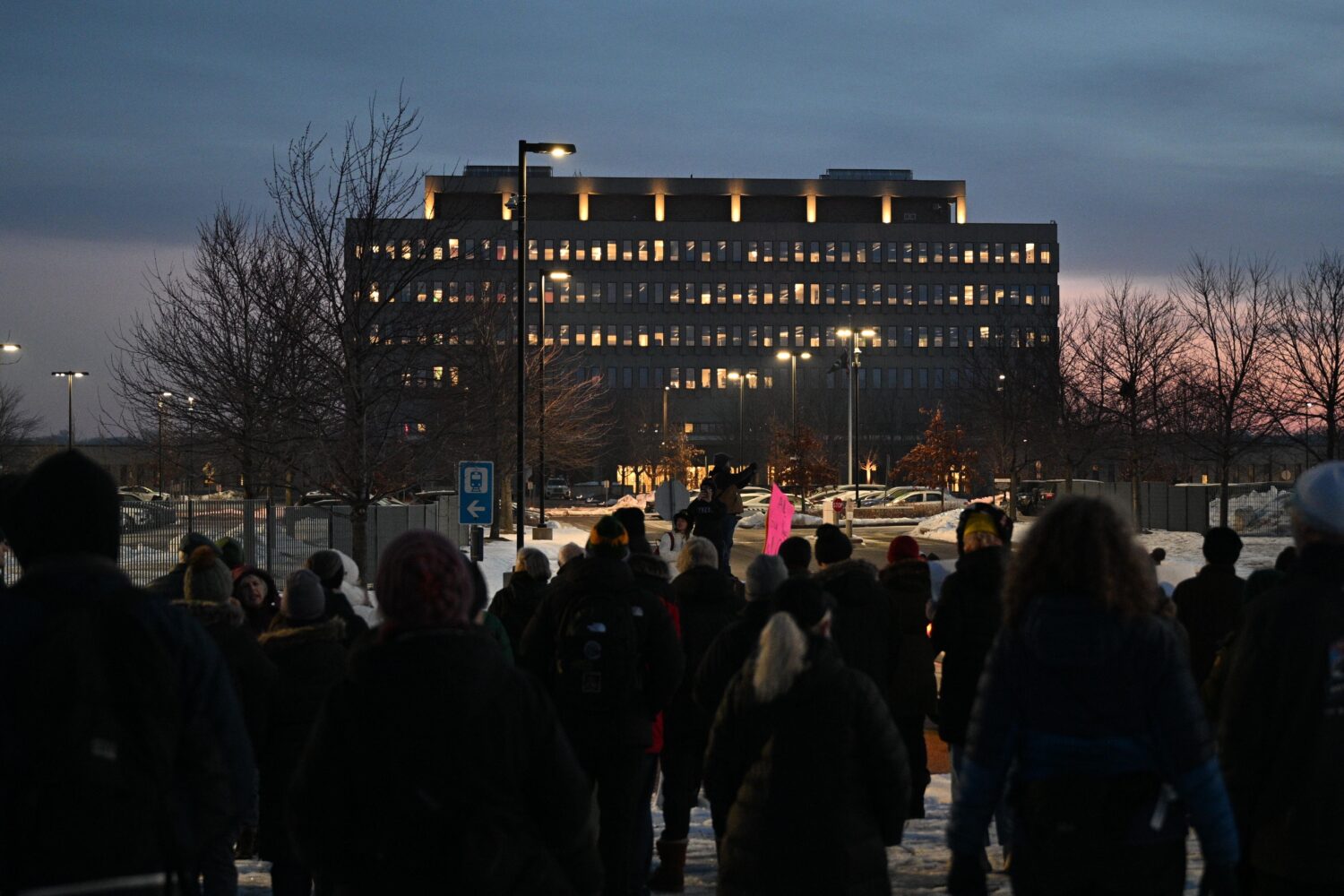 Protesters gather outside the Bishop Henry Whipple Federal Building, Thursday, Jan. 8, 2026, in Min...