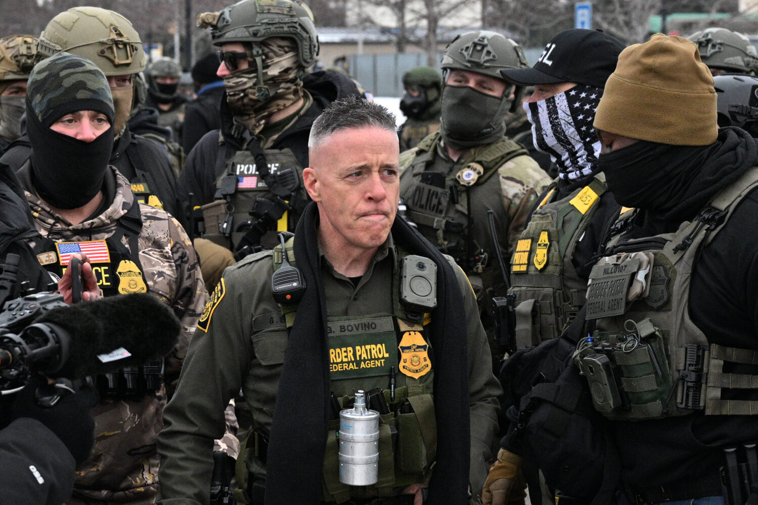 U.S. Border Patrol Cmdr. Gregory Bovino arrives as protesters gather outside the Bishop Henry Whipp...