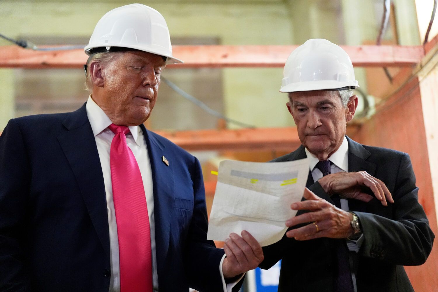 FILE - Federal Reserve Chairman Jerome Powell, right, and President Donald Trump look over a docume...