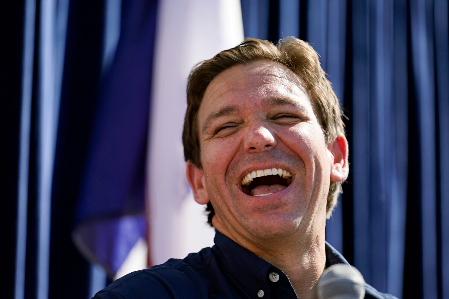 FILE - Republican presidential candidate Florida Gov. Ron DeSantis laughs at the Iowa State Fair, A...