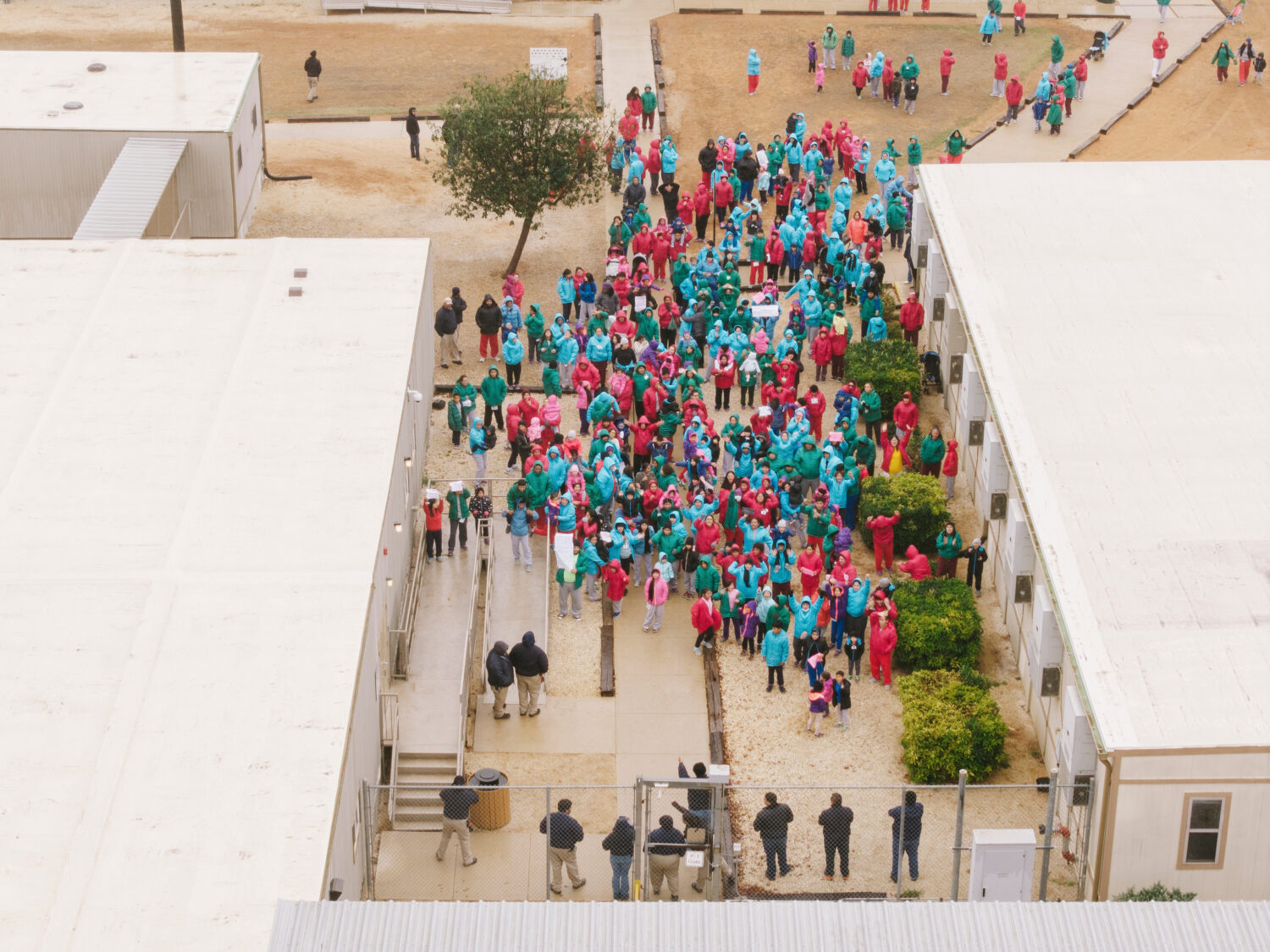 Detainees held at the South Texas Family Residential Center wave signs during a demonstration in Di...