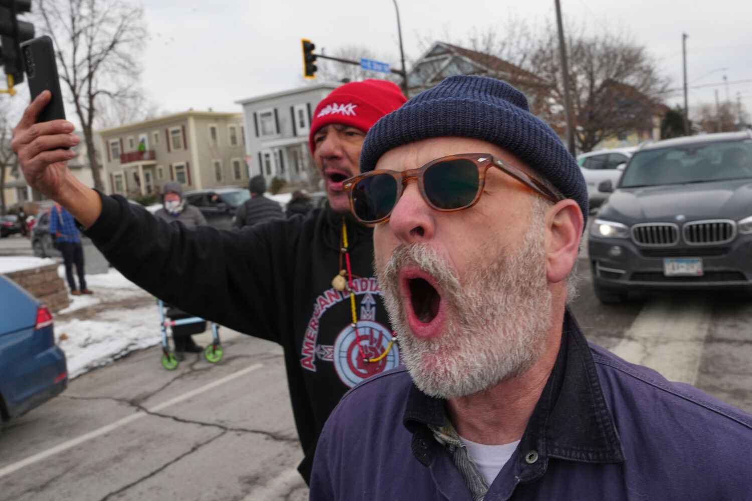 People shout toward Border Patrol agents making an arrest, Sunday, Jan. 11, 2026, in Minneapolis. (...