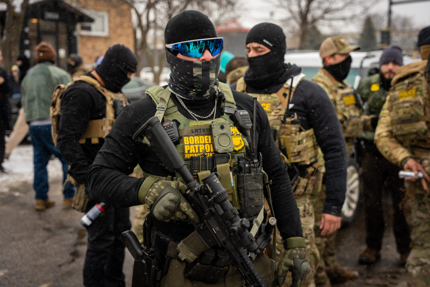 Federal agents stand guard, Wednesday, Jan. 21, 2026, in Minneapolis. (AP Photo/Angelina Katsanis)C...