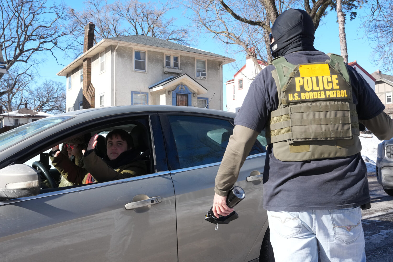 A federal agent approaches a vehicle on Thursday, Jan. 29, 2026, in Minneapolis. (AP Photo/Adam Gra...