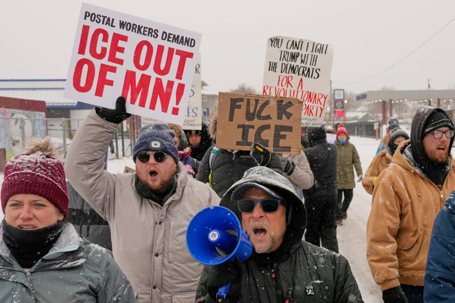 EDS NOTE: OBSCENITY - People march and gather near the post office during a protest, Sunday, Jan. 1...