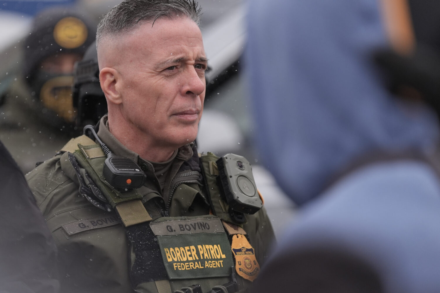 U.S. Border Patrol Cmdr. Gregory Bovino stands with Federal agents outside a convenience store on W...