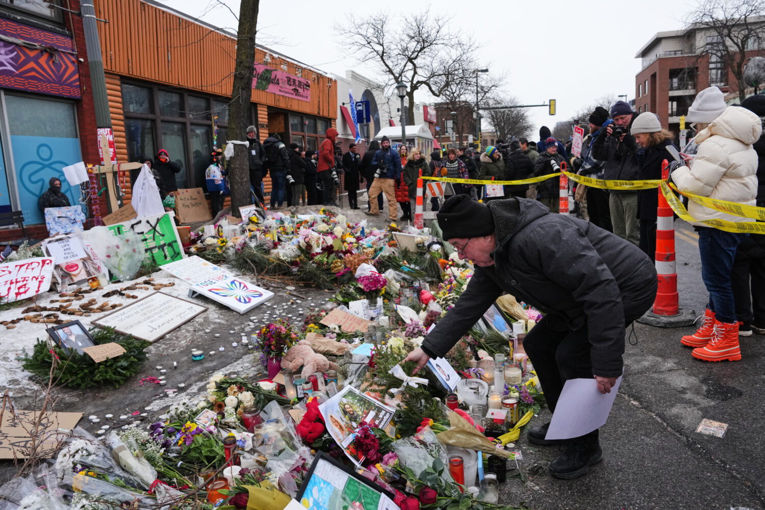 People visit a makeshift memorial for 37-year-old Alex Pretti, who was fatally shot by a U.S. Borde...