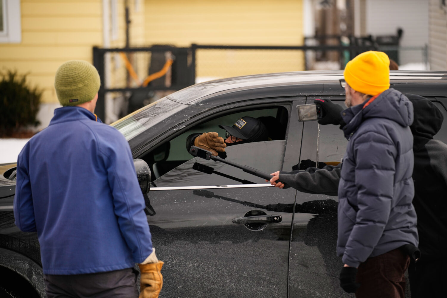 Bystanders film a federal immigration officer in their car Sunday, Jan. 11, 2026, in Minneapolis. (...