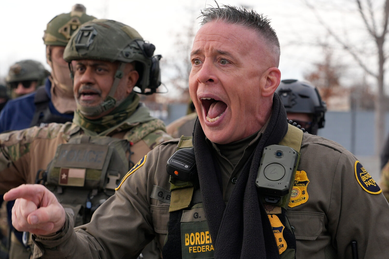 U.S. Border Patrol Cmdr. Gregory Bovino shouts at protesters, Sunday, Jan. 11, 2026, in Minneapolis...