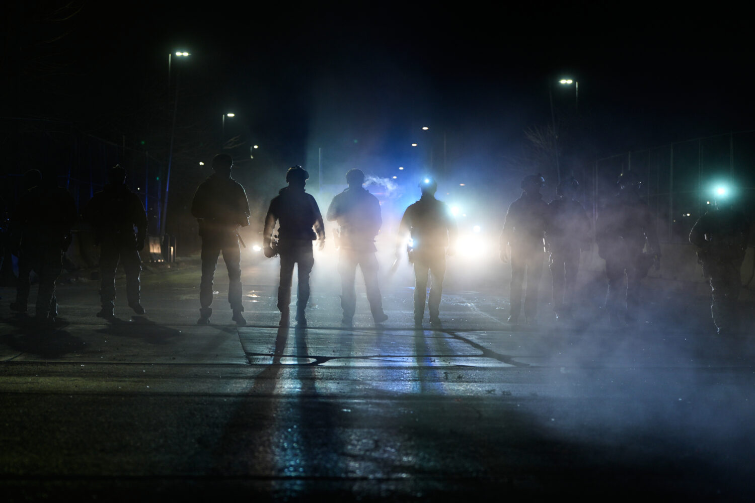 Federal immigration officers are seen outside Bishop Whipple Federal Building after tear gas was de...