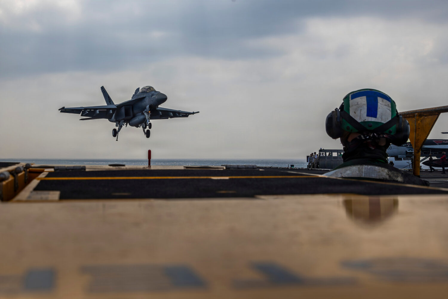 This photo provided by the U.S. Navy shows a Boeing F/A-18E Super Hornet landing on the Nimitz-clas...