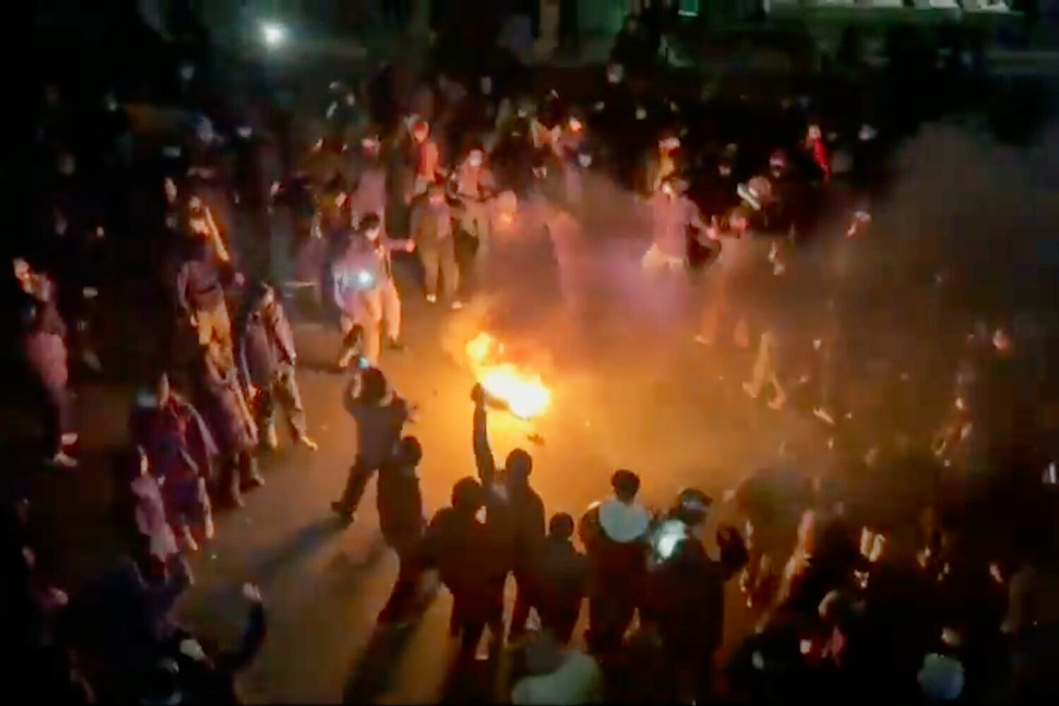 FILE - In this frame grab from footage circulating on social media shows protesters dancing and che...