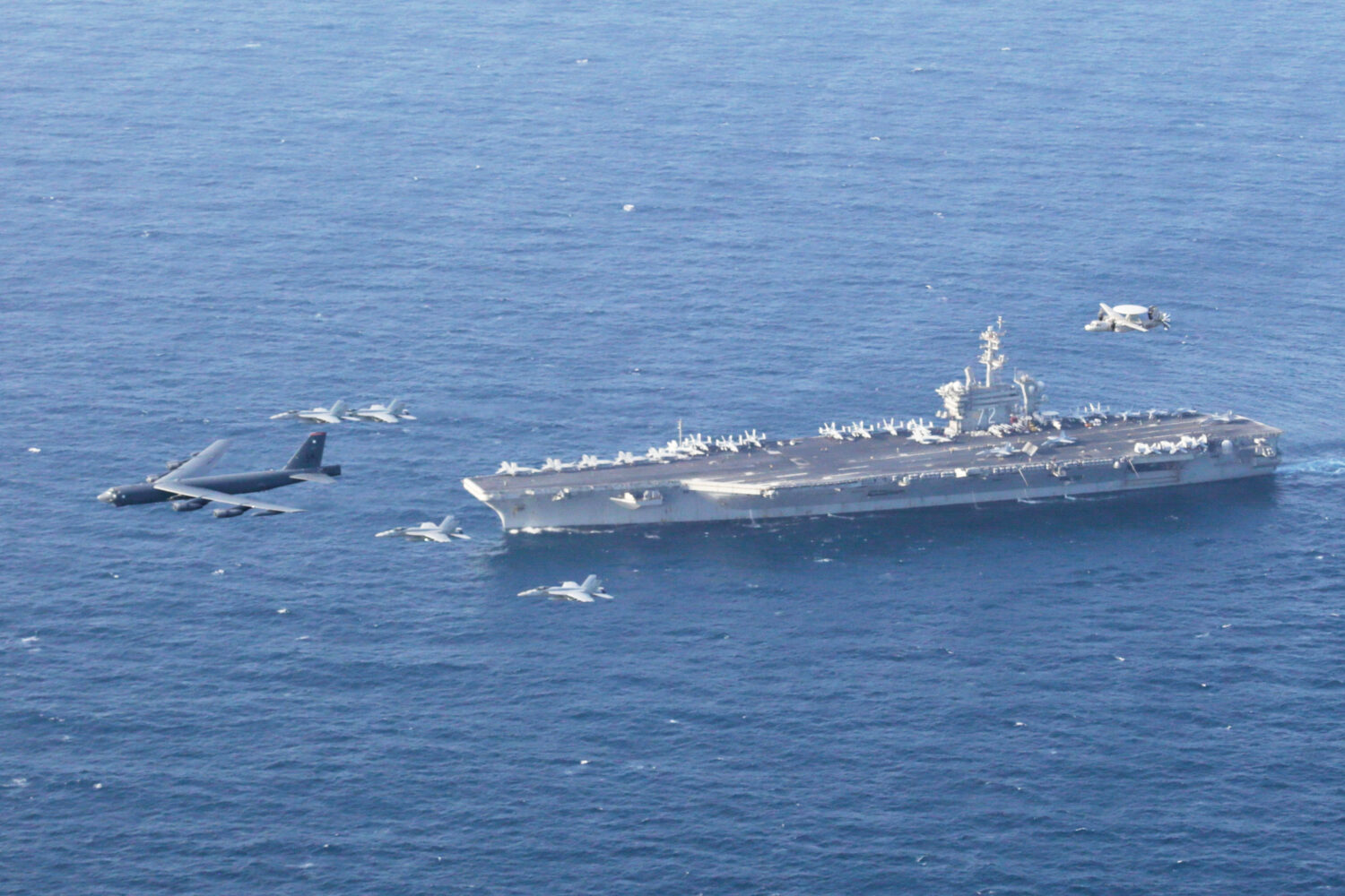 FILE - The USS Abraham Lincoln carrier and a U.S. Air Force B-52H Stratofortress, conduct joint exe...