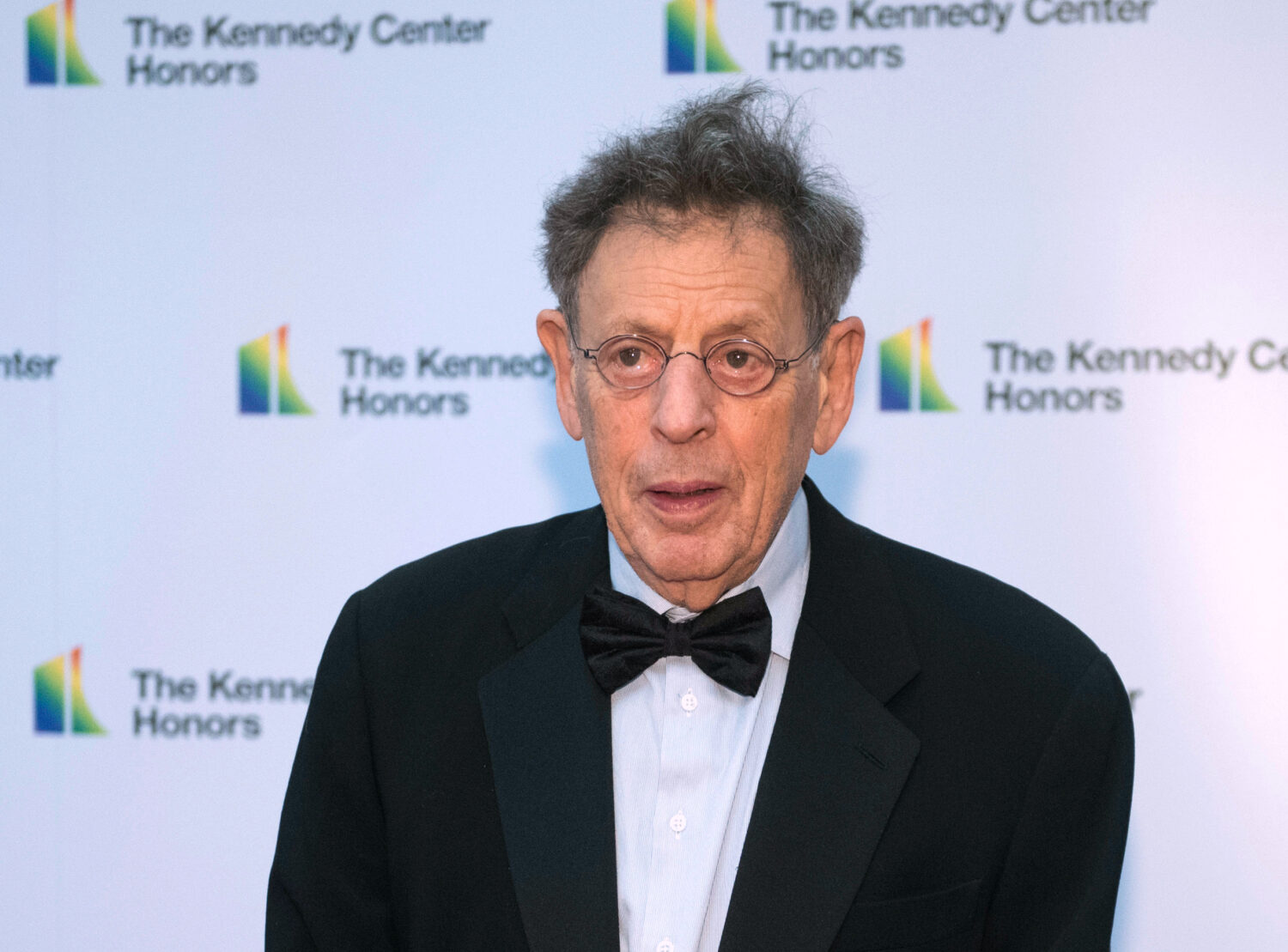 FILE - 2018 Kennedy Center Honoree composer Philip Glass arrives at the State Department for the Ke...