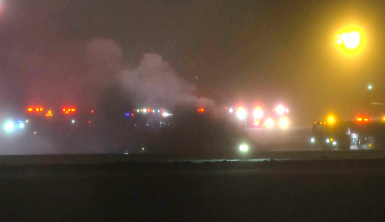 This image taken from video provided by WABI television, emergency services work on a scene of the ...