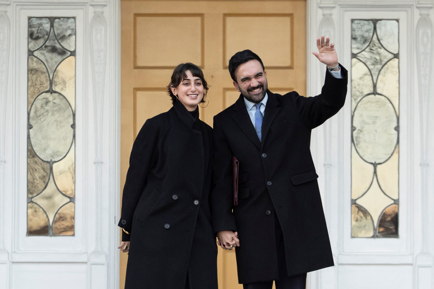 New York Mayor Zohran Mamdani, right, and his wife Rama Duwaji wave at members of media after a new...
