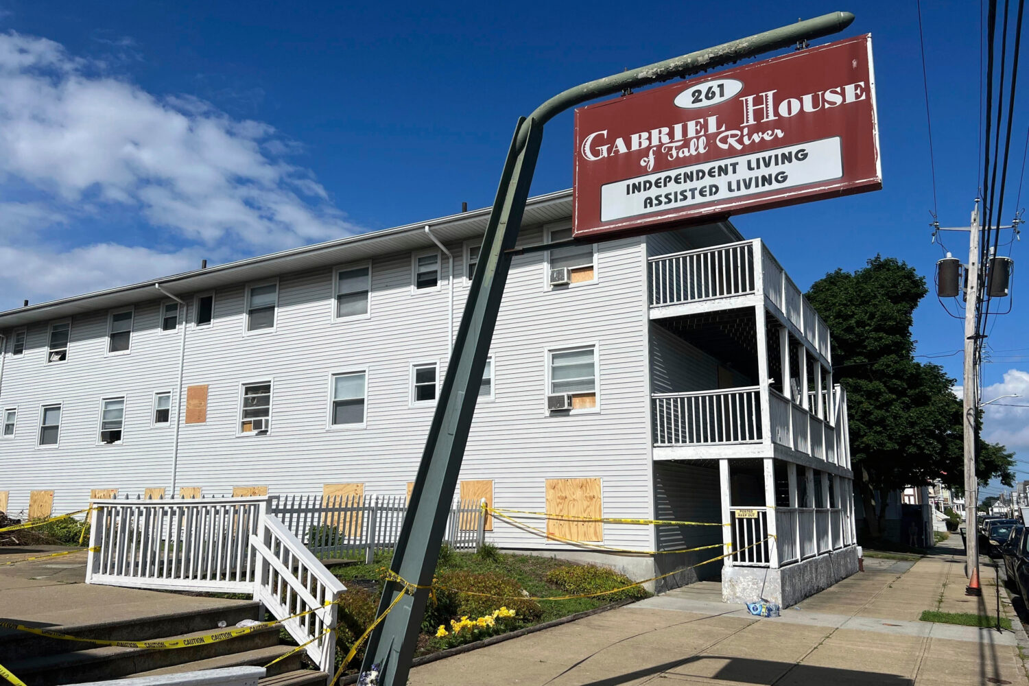 FILE - Boards cover the windows of the Gabriel House assisted living facility, where a fire killed ...