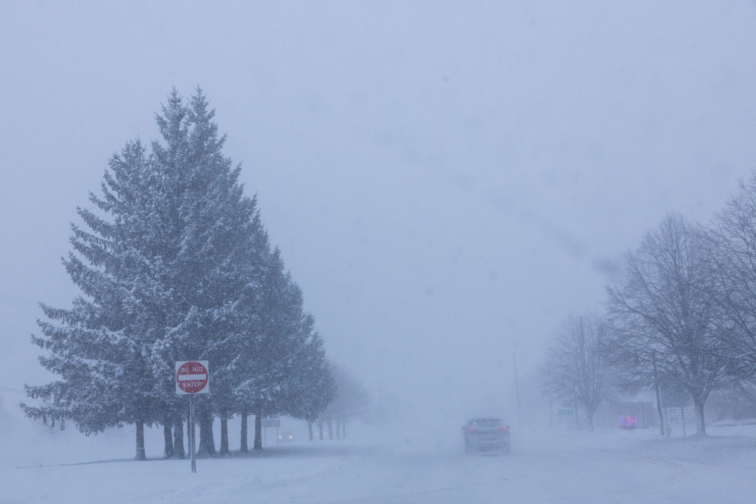 Vehicles are driven through whiteout conditions along Lake Michigan Drive during a winter storm war...