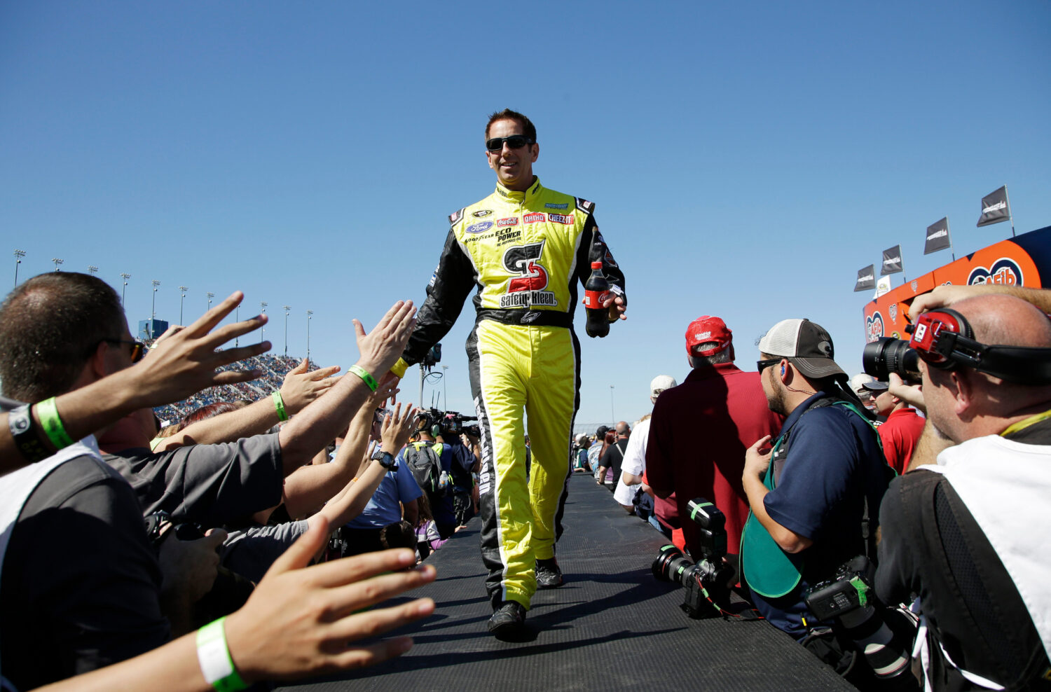 FILE - Greg Biffle greets fans during drivers introduction before the NASCAR Sprint Cup Series auto...