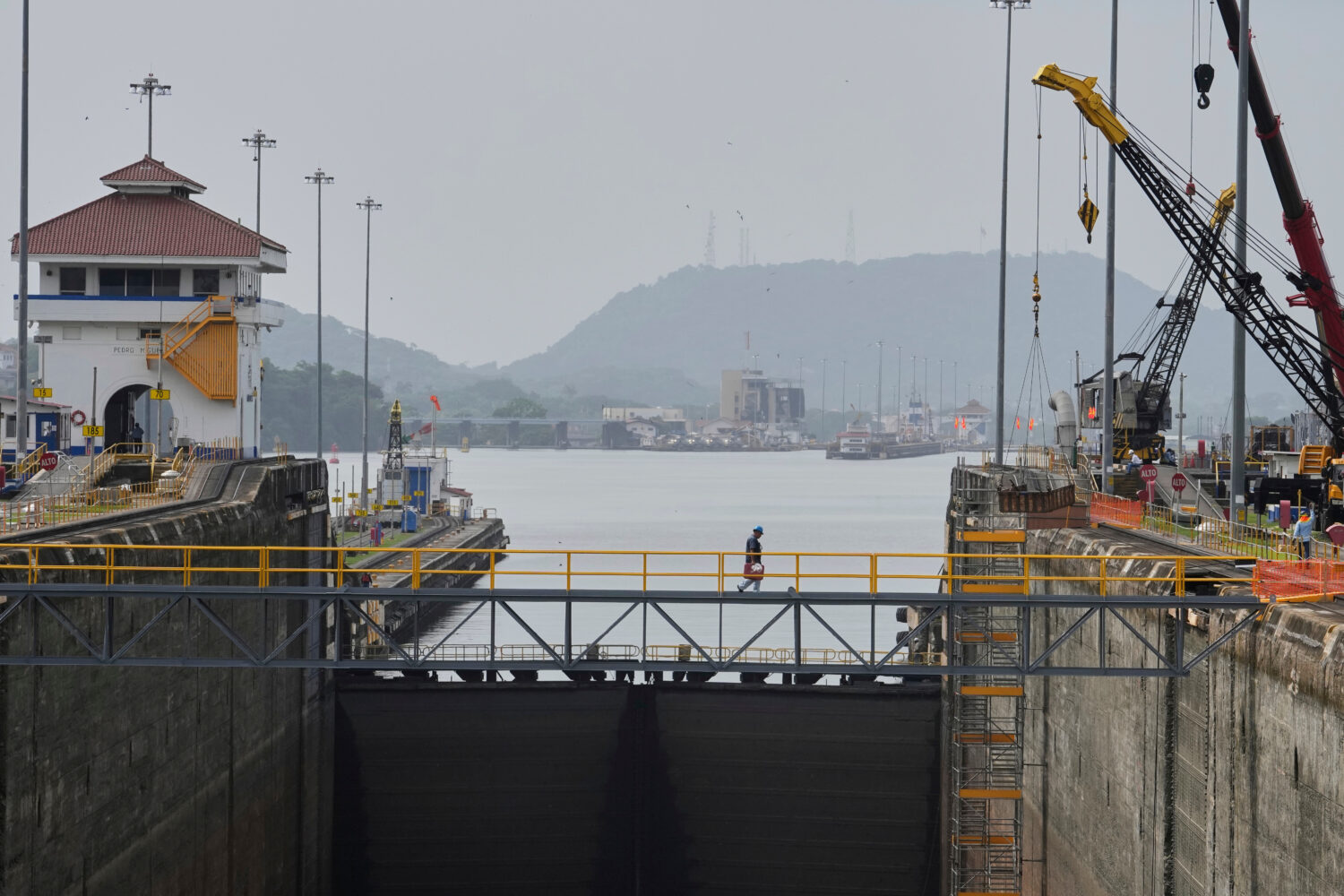 FILE - Workers carry out maintenance at the Pedro Miguel locks of the Panama Canal during routine u...