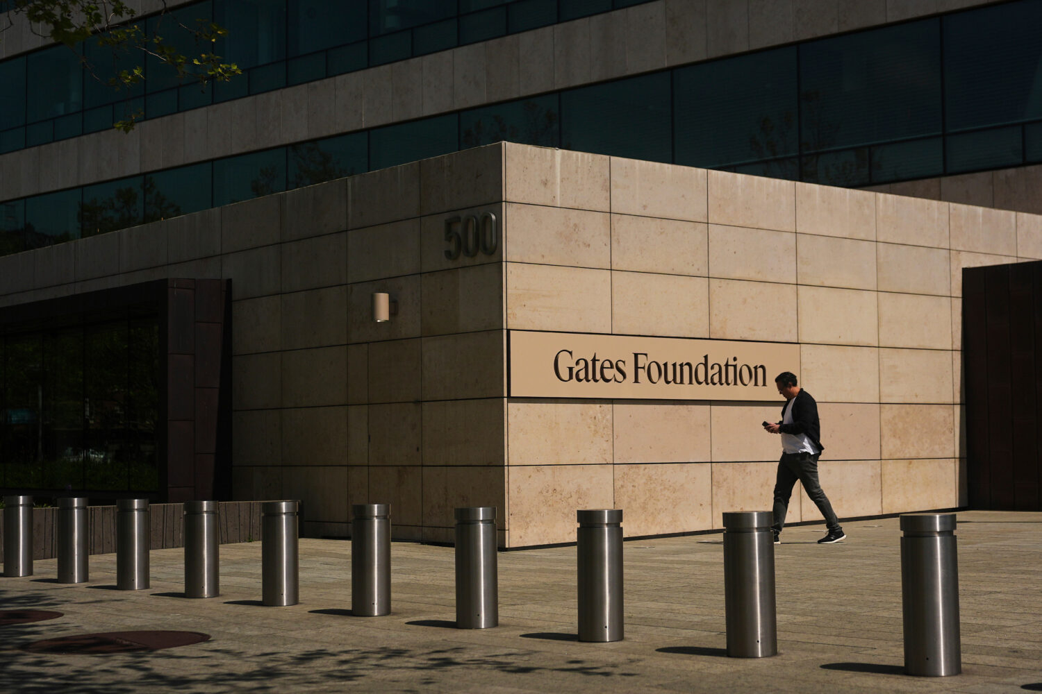 FILE - A person walks outside of the Gates Foundation campus Wednesday, April 30, 2025, in Seattle....
