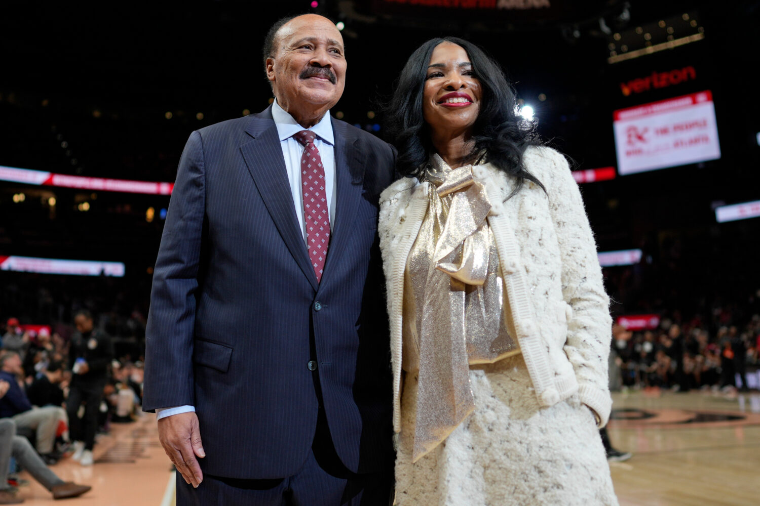 Martin Luther King III, and his wife Arndrea Waters King smile during the second half of an NBA bas...