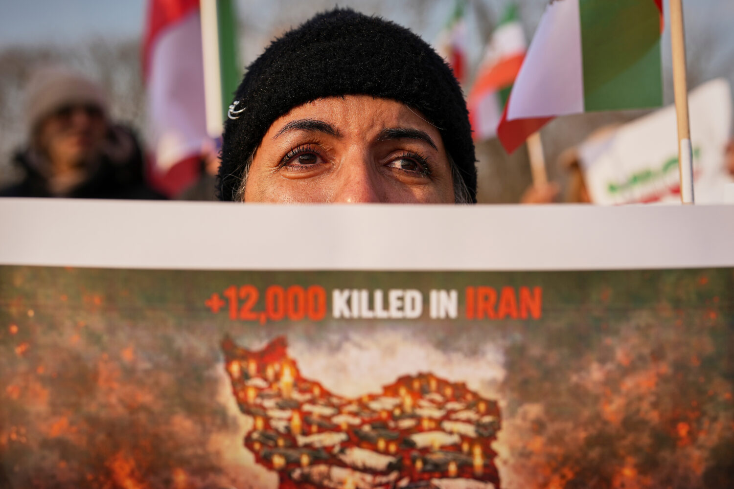 A woman cries as members of the Iranian community stage a rally in support of anti-government prote...