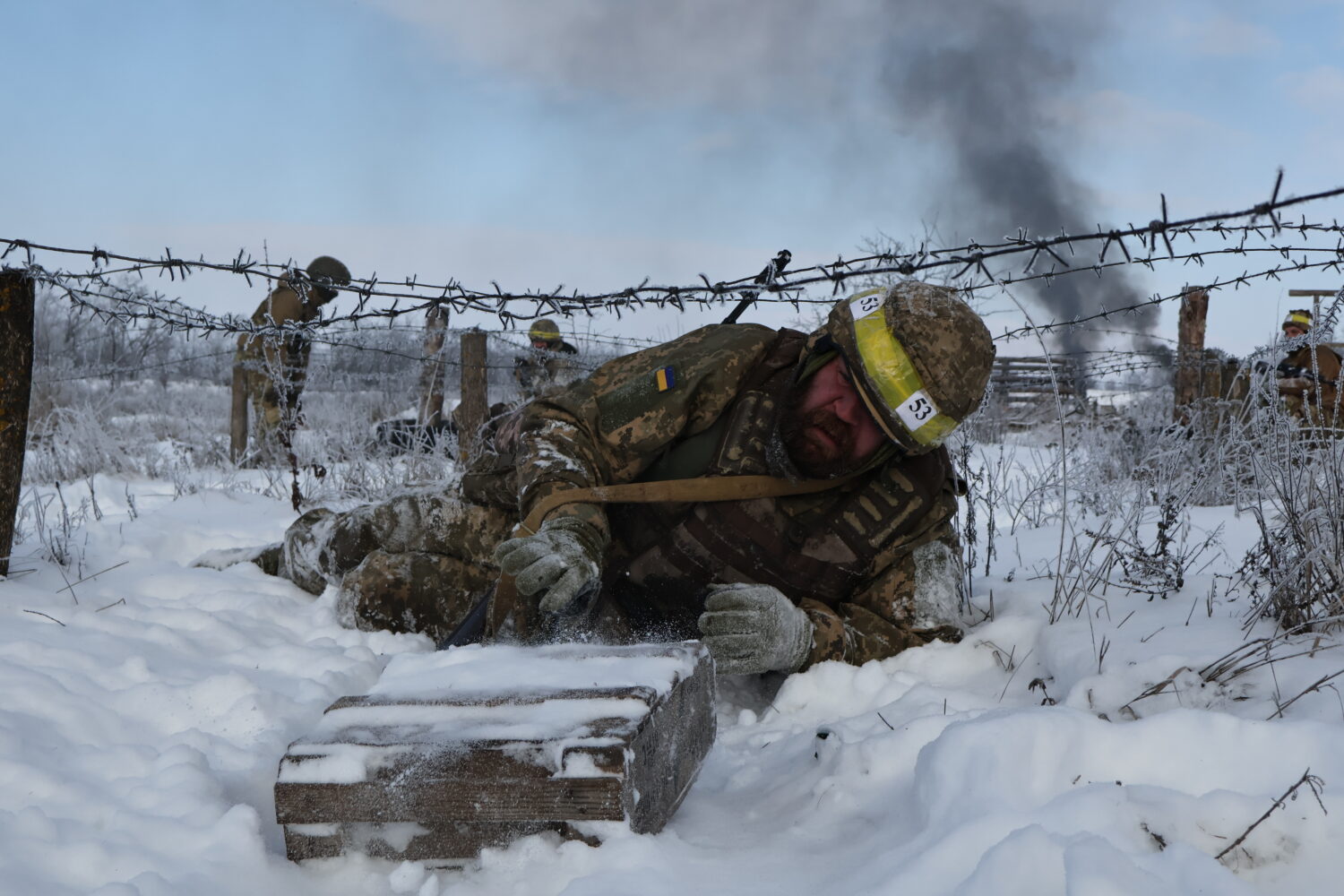 In this photo provided by Ukraine's 65th Mechanized Brigade press service, recruits perform drills ...
