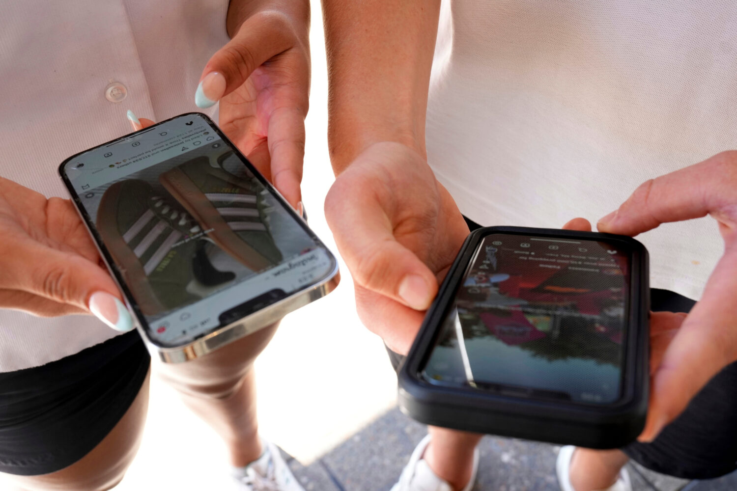 FILE - Young people use their phones to view social media in Sydney, Nov. 8, 2024. (AP Photo/Rick R...