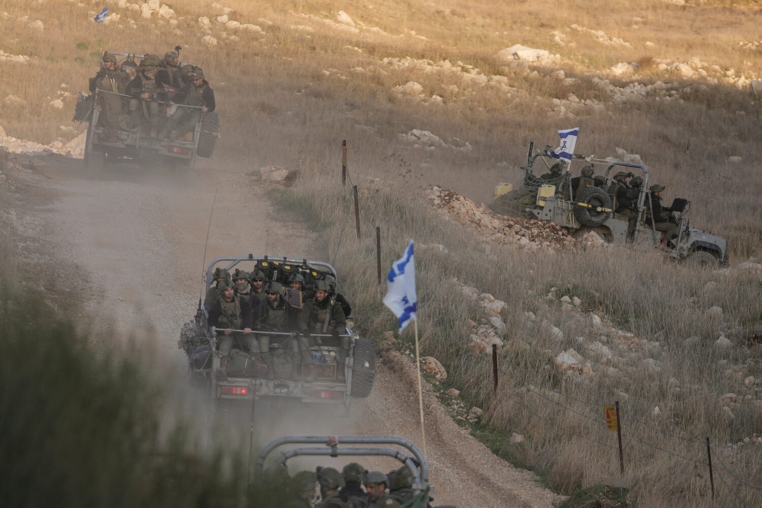 FILE - Israeli soldiers cross the security fence moving towards the so-called Alpha Line that separ...