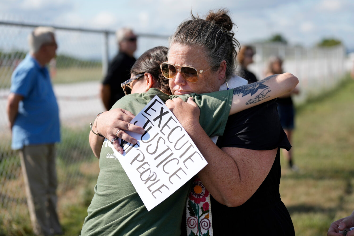 FILE - India Pungarcher, left, hugs Rev. Ingrid McIntyre as demonstrators gather in the area reserv...