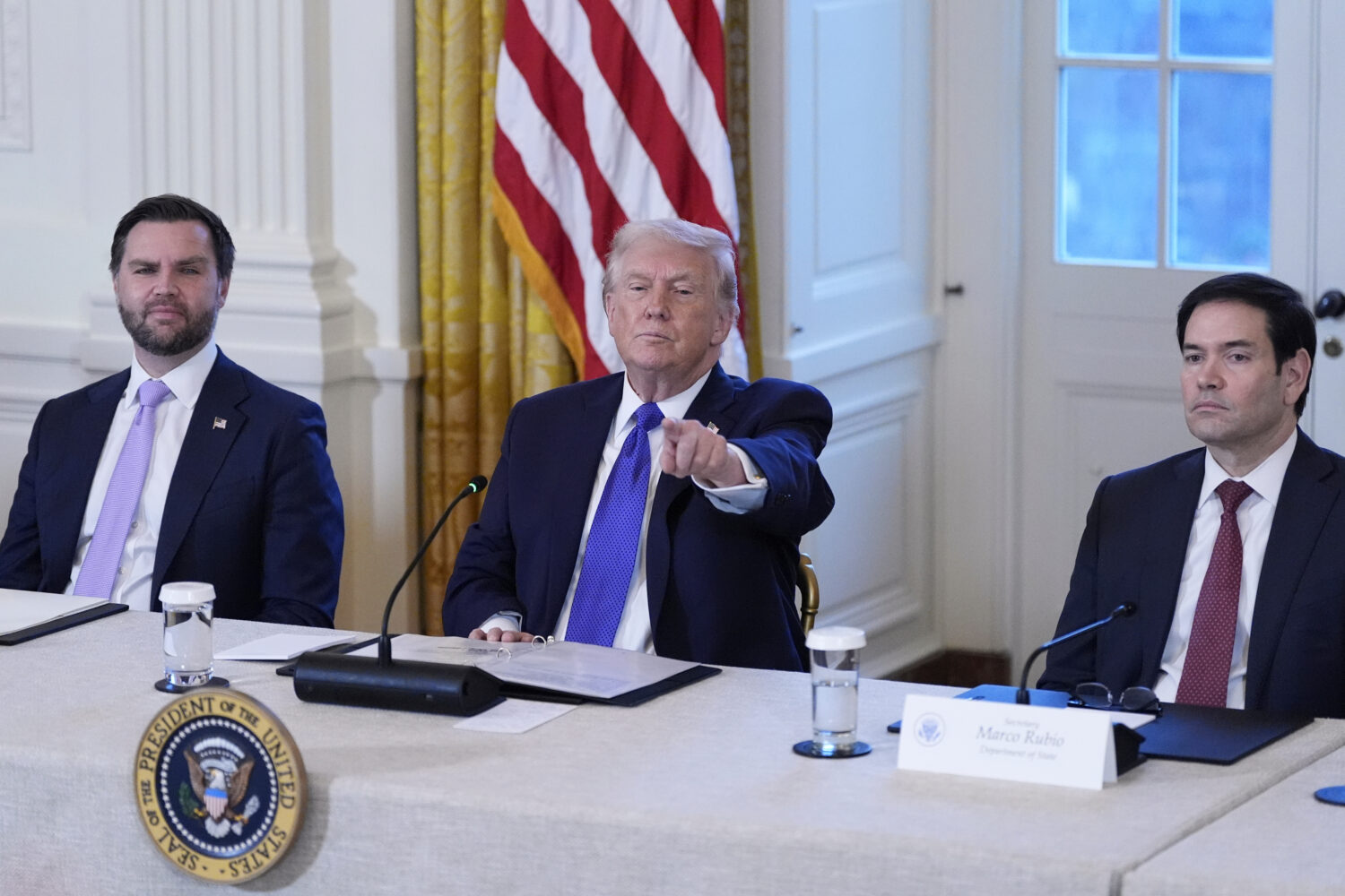 President Donald Trump chooses a reporter to ask a question with Vice President JD Vance, left, and...