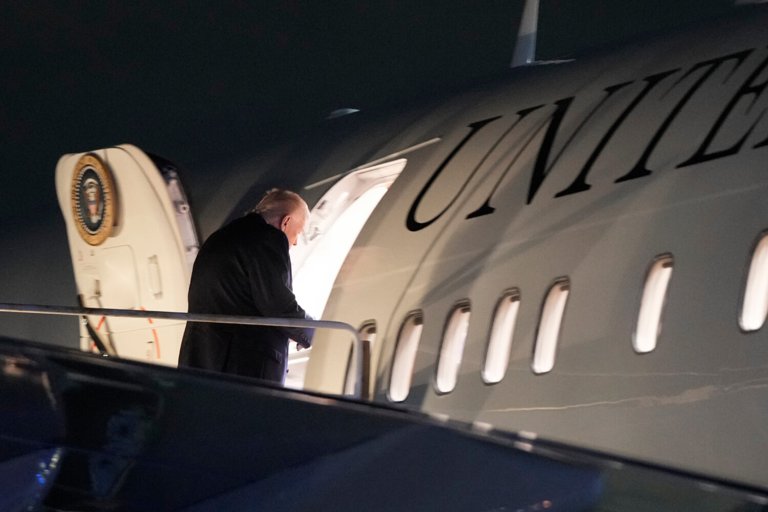 President Donald Trump boards Air Force One at Palm Beach International Airport, Sunday, Jan. 11, 2...