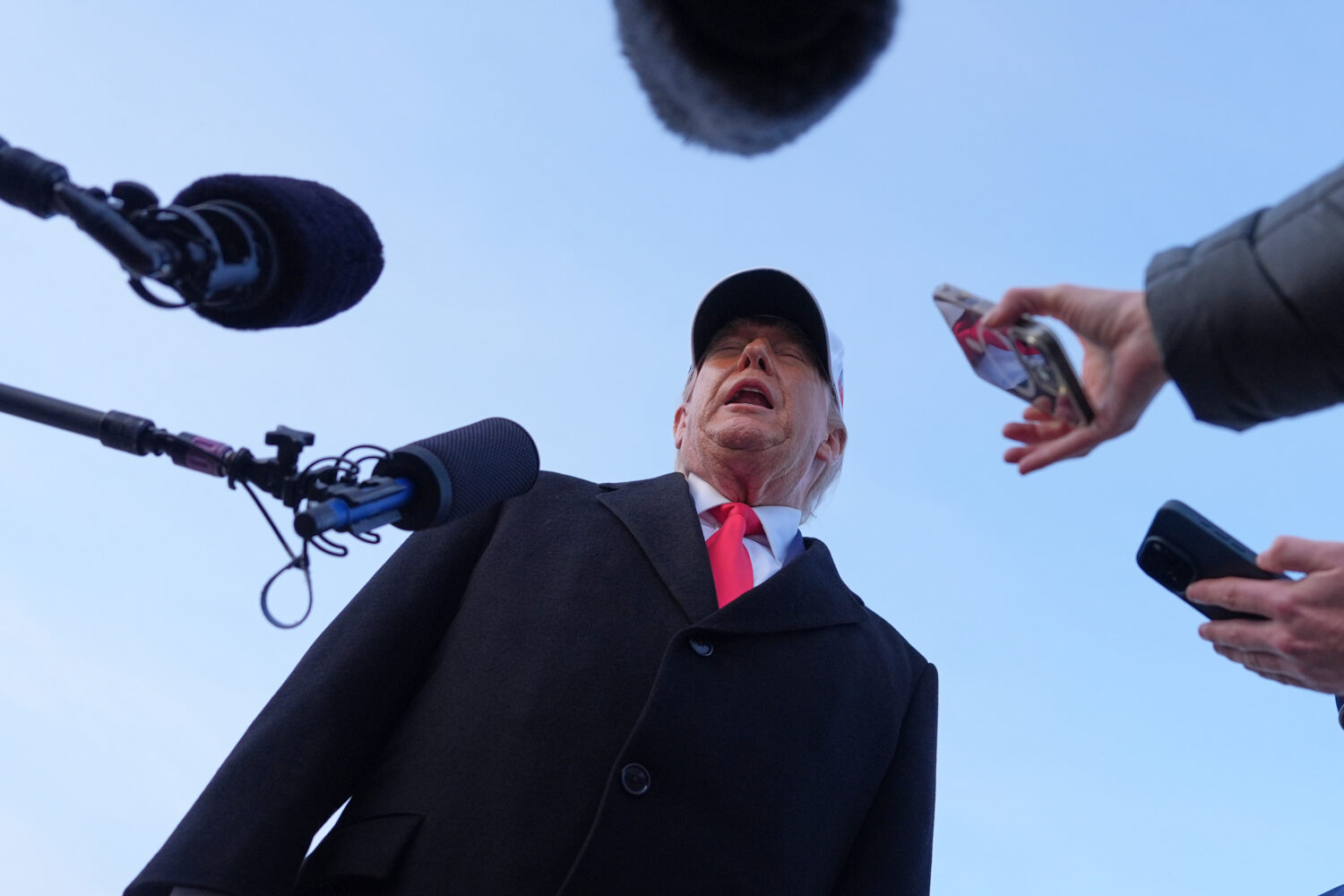 President Donald Trump speaks with reporters at Joint Base Andrews, Tuesday, Jan. 13, 2026, in Join...