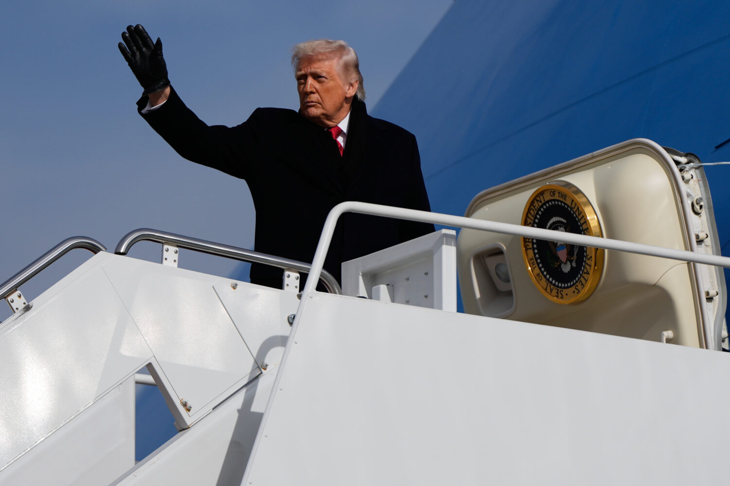 President Donald Trump boards Air Force One, Friday, Jan. 16, 2026, at Joint Base Andrews, Md. (AP ...