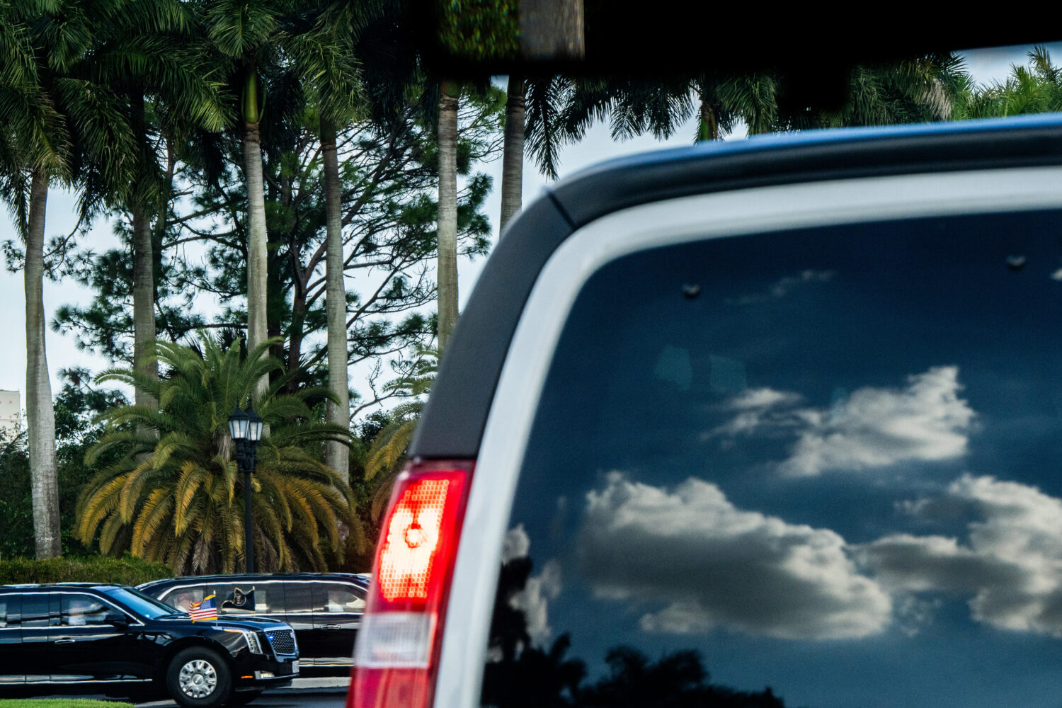 President Donald Trump departs Trump International Golf Club in the presidential limousine, known a...