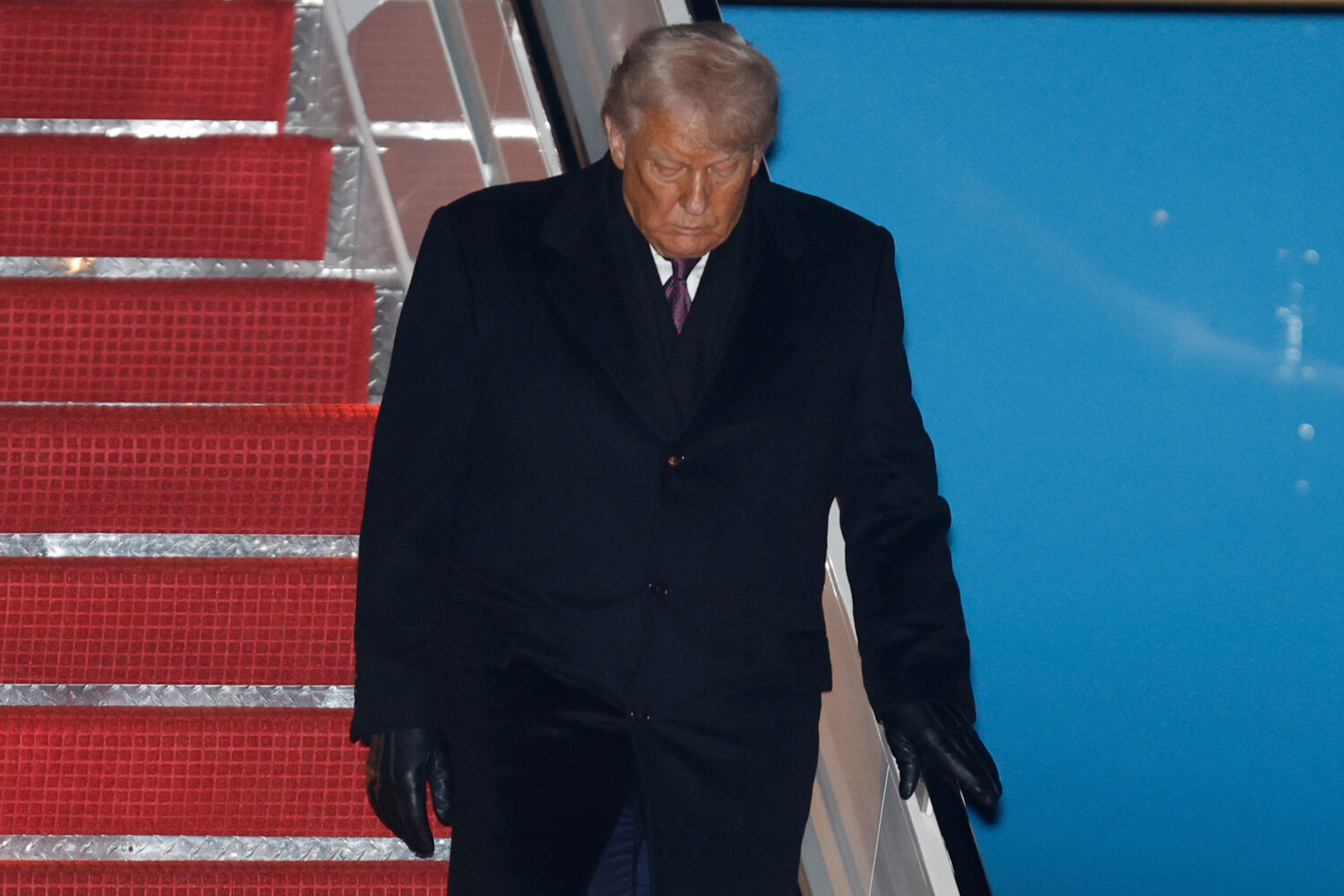 President Donald Trump walks down the stairs of Air Force One upon his arrival at Joint Base Andrew...