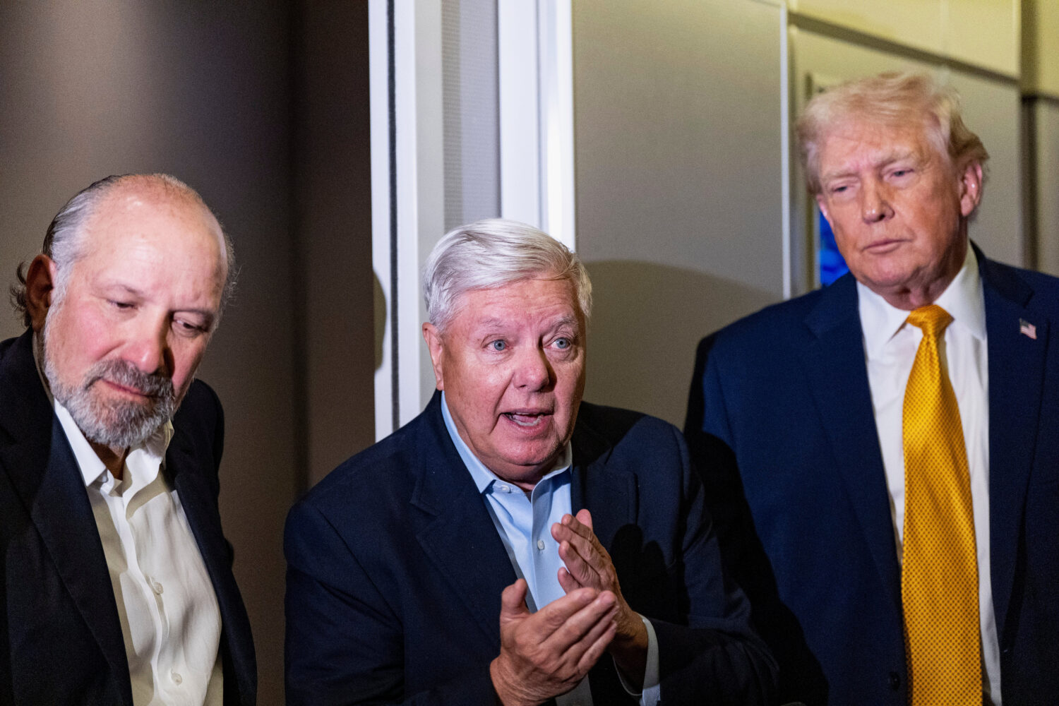 President Donald Trump, accompanied by Commerce Secretary Howard Lutnick, left, and Sen. Lindsey Gr...