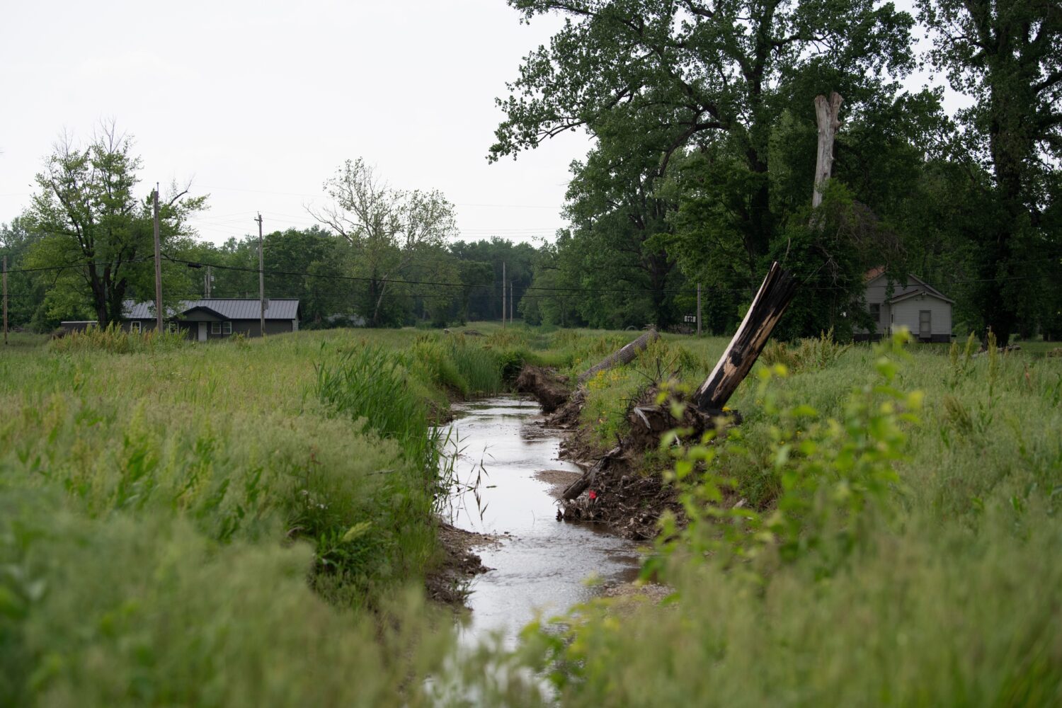 Water flows near homes in flood-prone Cahokia Heights, Ill., May 15, 2025. (AP Photo/Michael Philli...
