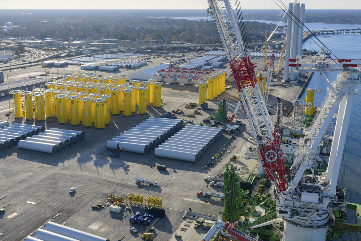 FILE - Wind turbine bases, generators and blades sit along with support ships at The Portsmouth Mar...